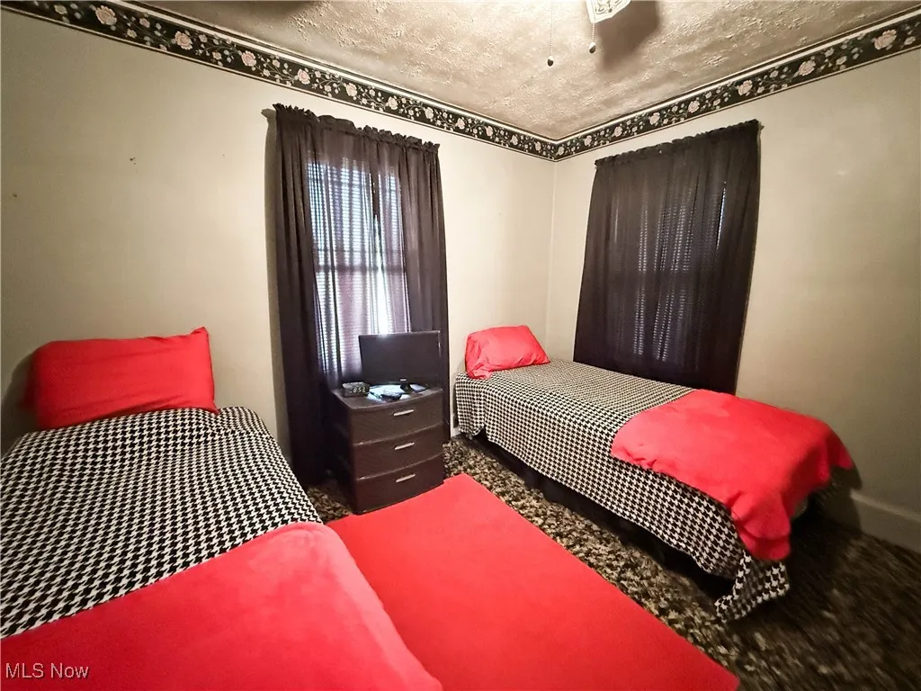 Carpeted bedroom with a textured ceiling