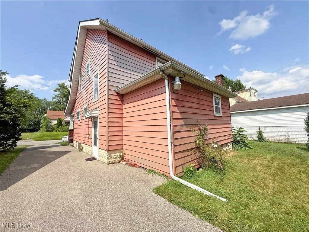 View of side of property with a yard
