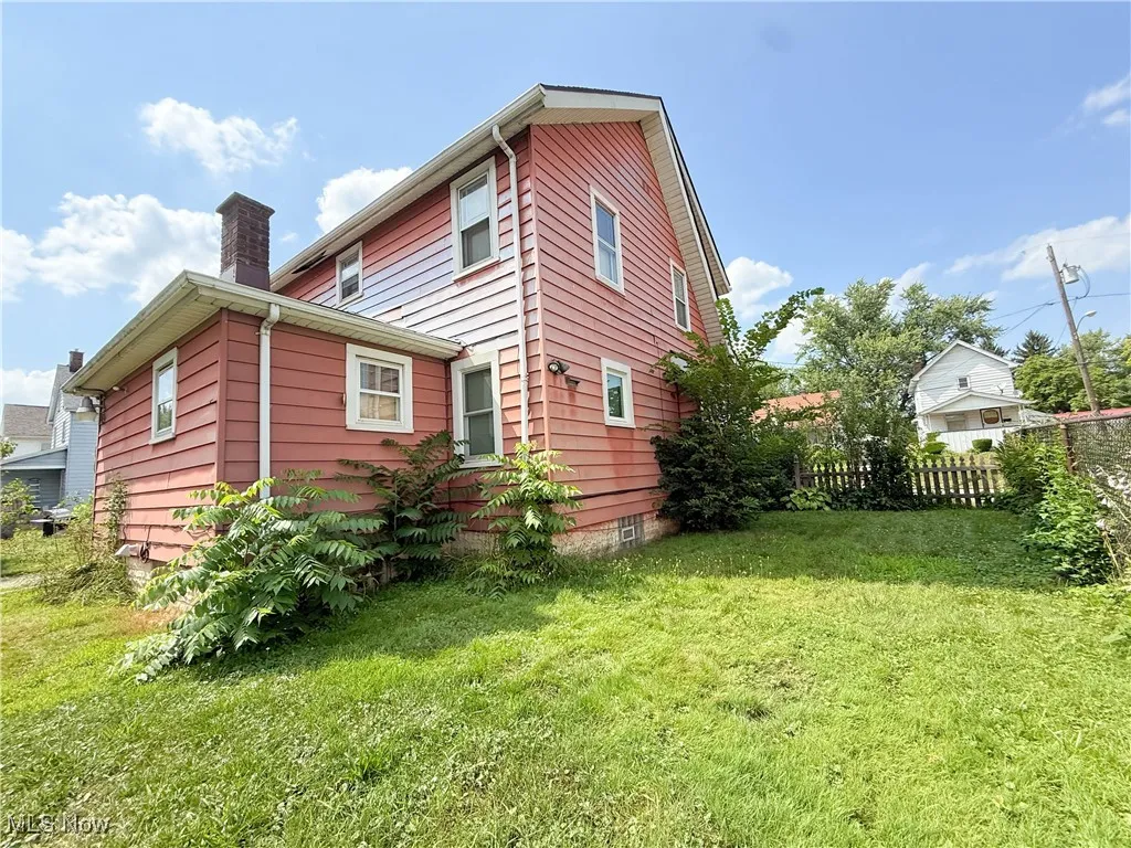 Rear view of house featuring a chimney