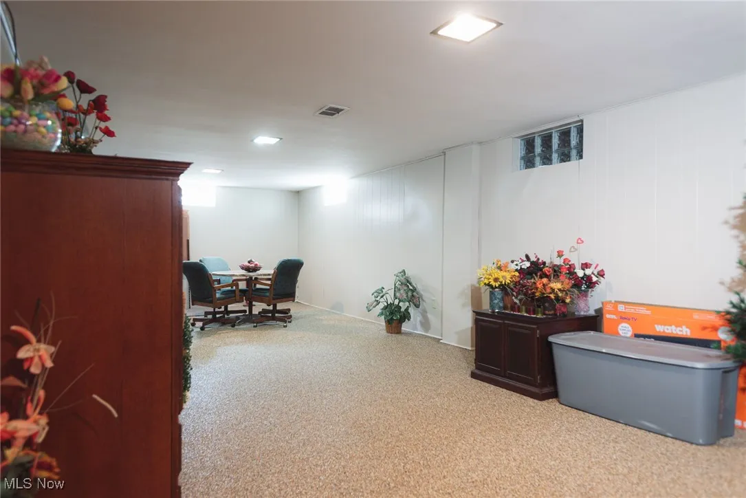 Office area featuring carpet and wood walls
