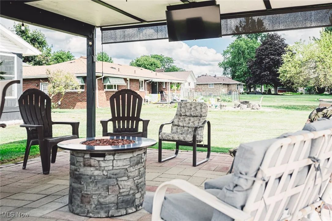 View of patio featuring an outdoor fire pit