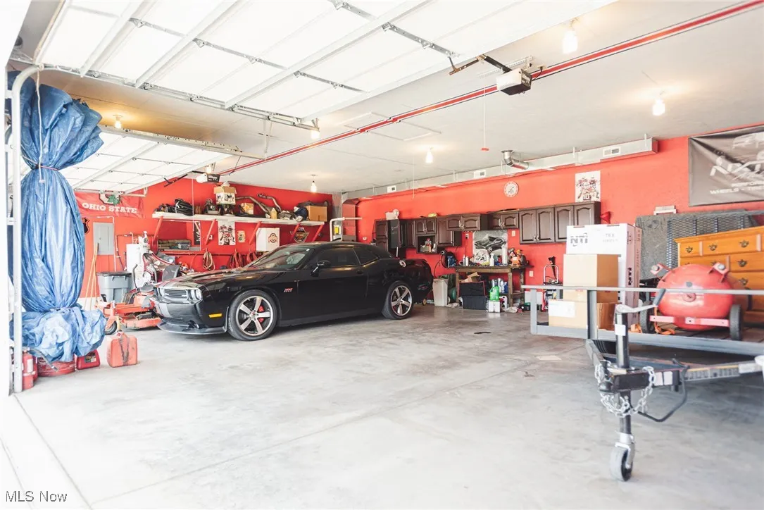 Garage featuring a workshop area and a garage door opener