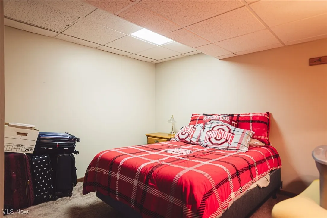 Bedroom featuring carpet flooring and a paneled ceiling