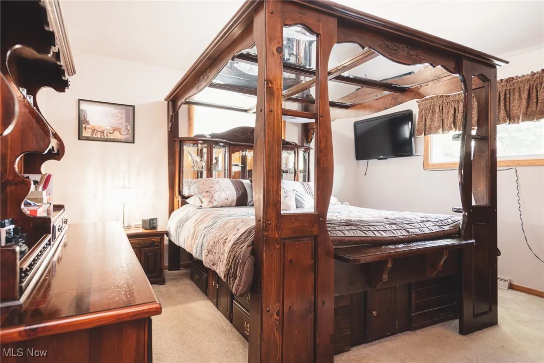 Bedroom featuring light carpet