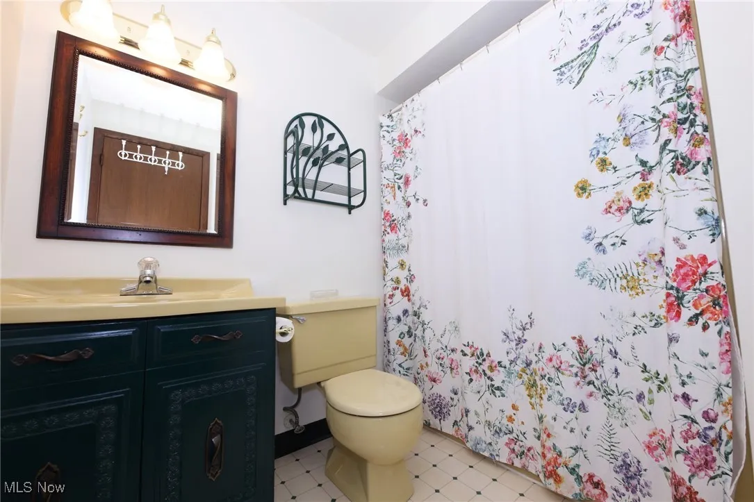 Full bath featuring vanity and a shower with curtain