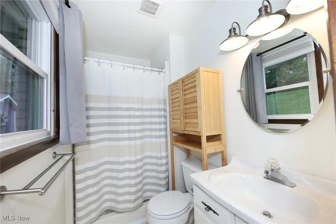 Full bathroom featuring vanity and shower / bath combo with shower curtain