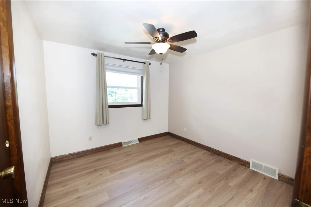 Spare room featuring light wood-type flooring and ceiling fan