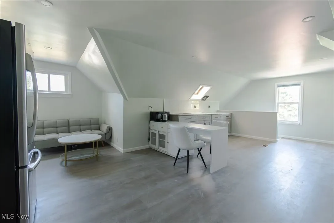 Additional living space with healthy amount of natural light, lofted ceiling, and recessed lighting