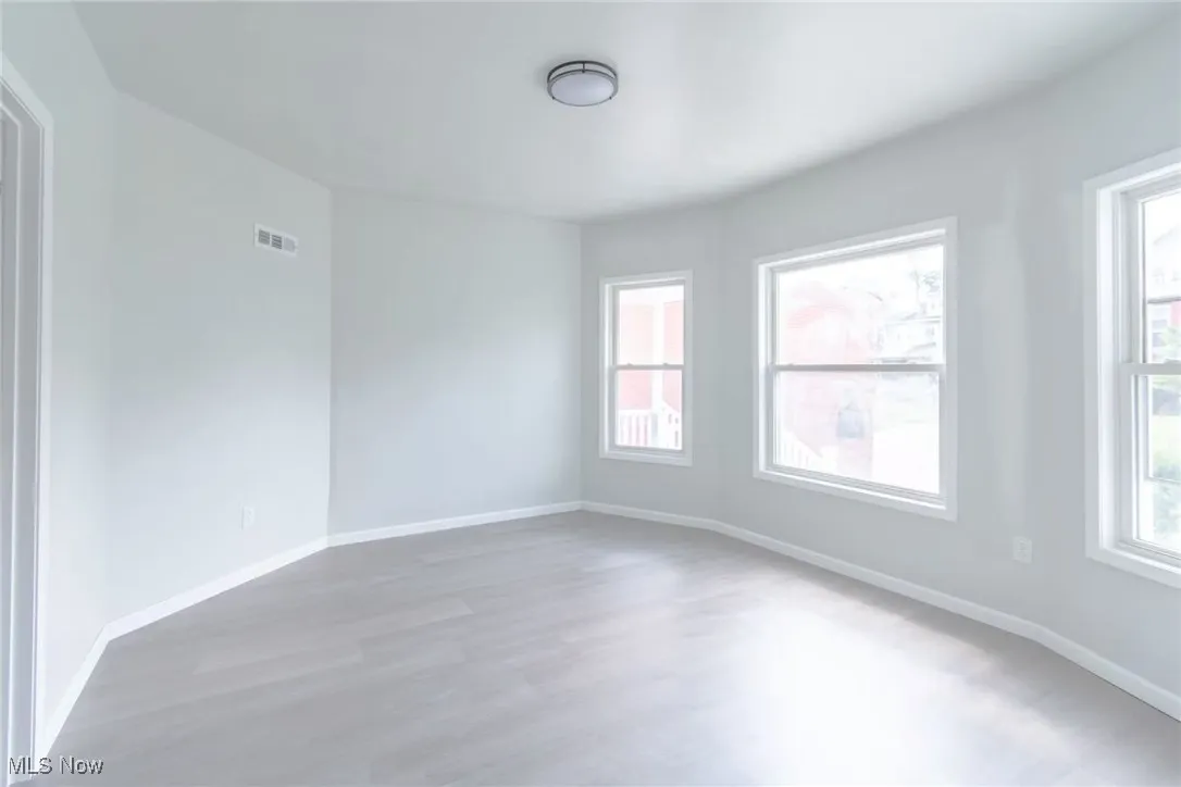 Unfurnished room featuring healthy amount of natural light and light wood finished floors