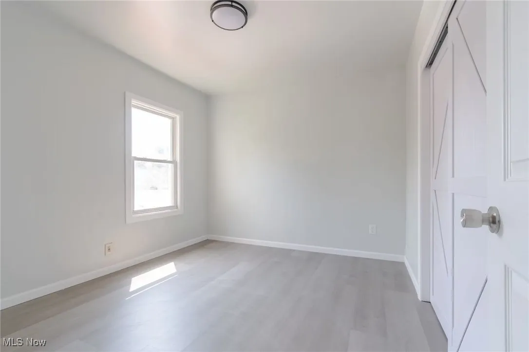 Unfurnished bedroom featuring a closet and light wood-type flooring