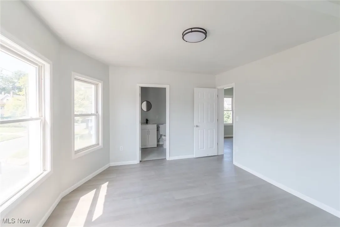 Unfurnished room with baseboards and light wood-type flooring