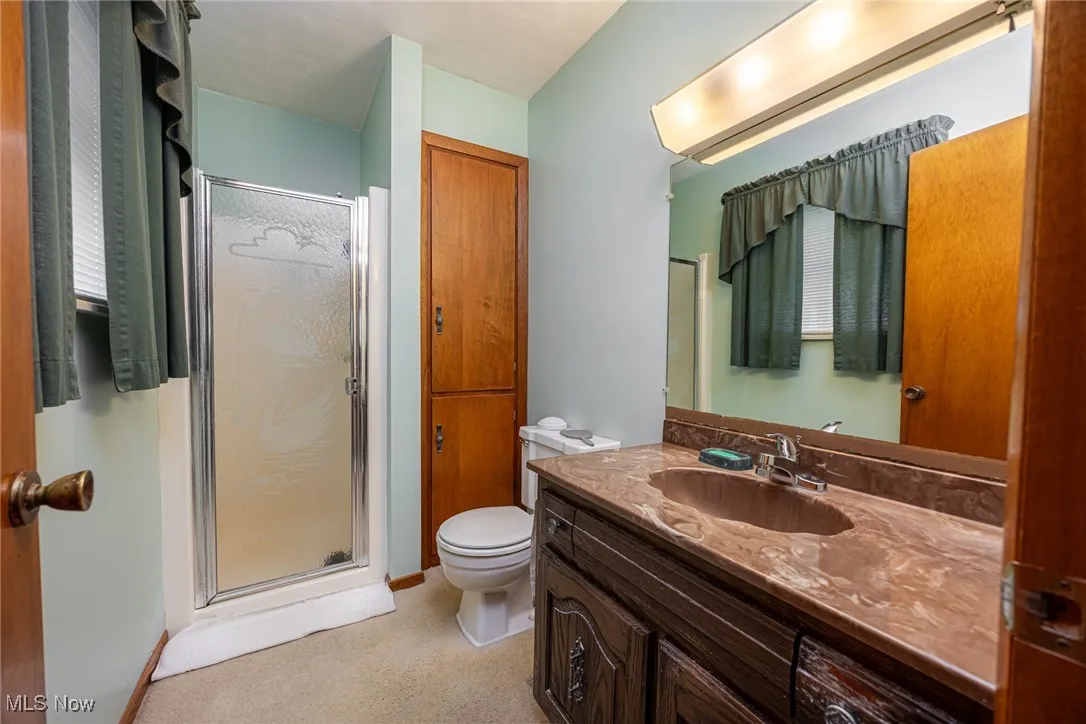 Bathroom with vanity and a shower stall