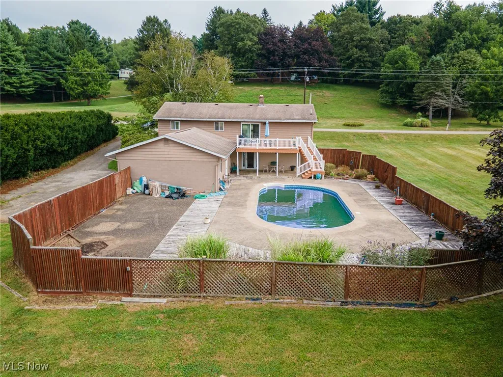 View of swimming pool featuring a patio area, stairs, a fenced backyard, and a deck