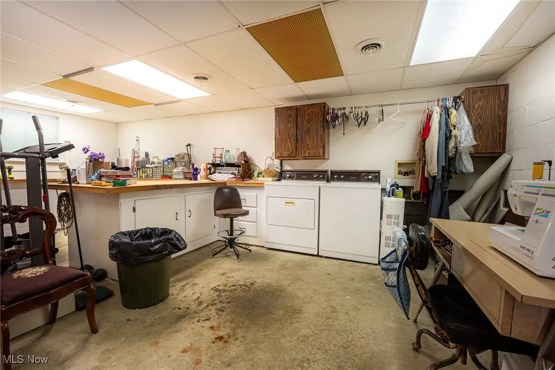 Basement featuring washer and clothes dryer and a paneled ceiling