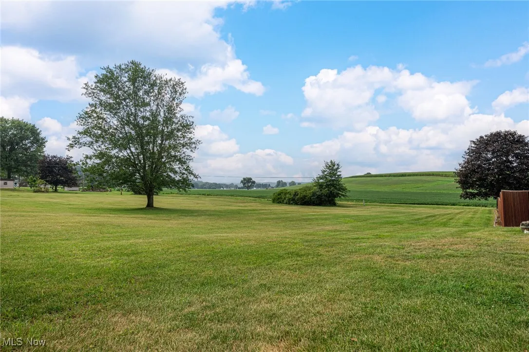 View of grassy yard with a rural view