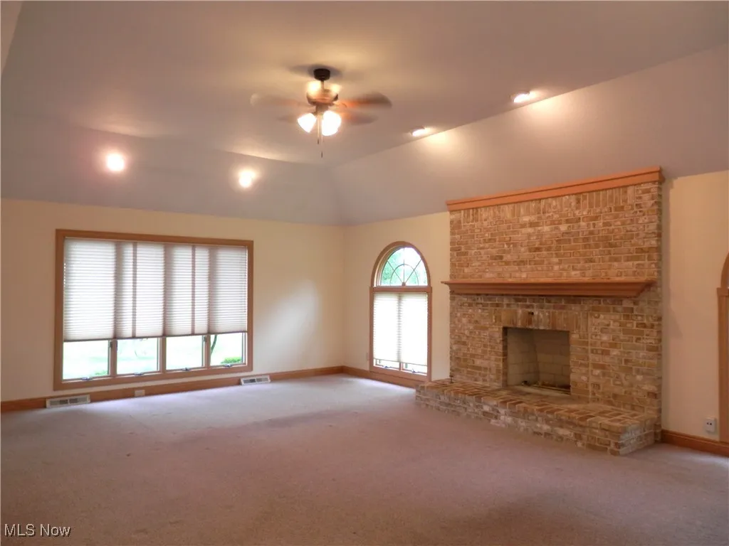 Living room with fireplace and ceiling fan