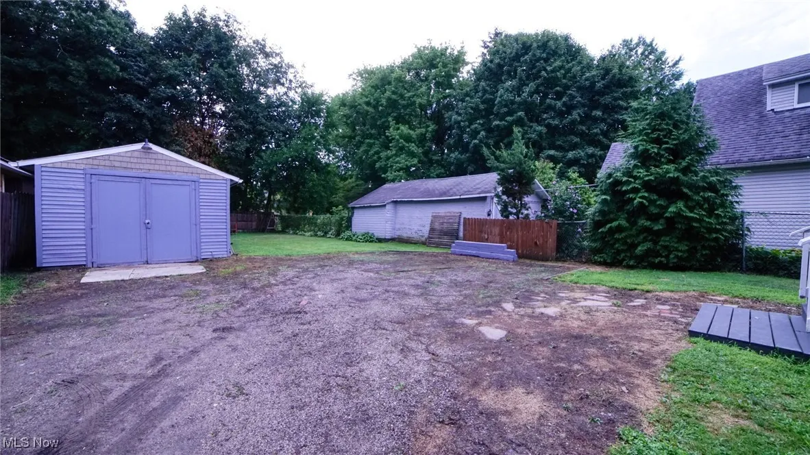 View of yard featuring a 1 car detached garage