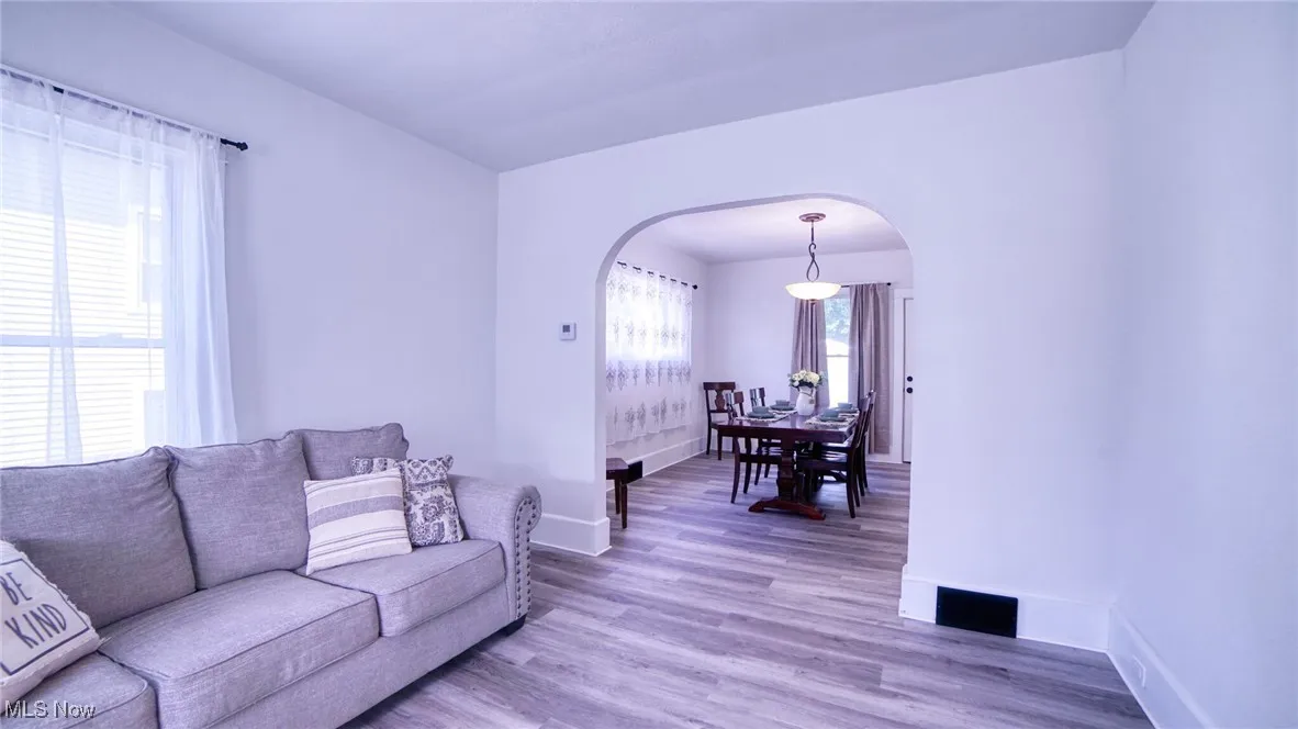 Living area with LVP floors and arched walkways