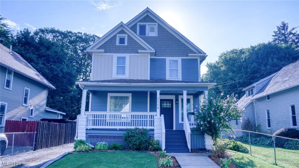 View of front of property with covered porch and board and batten siding