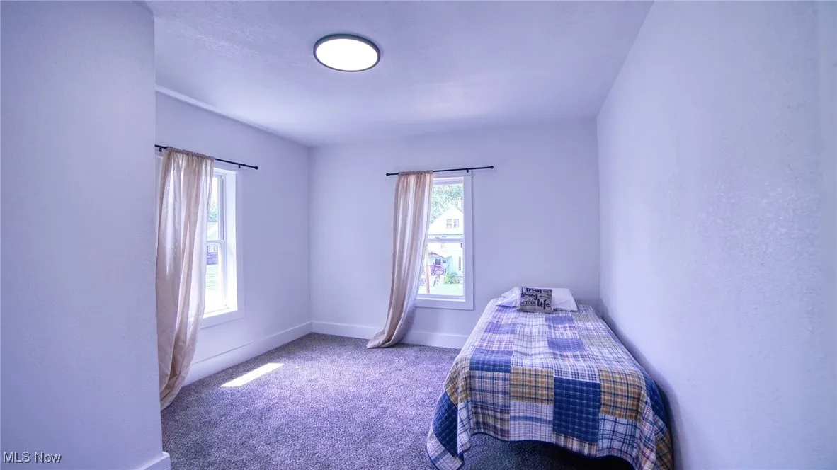 Carpeted bedroom featuring baseboards