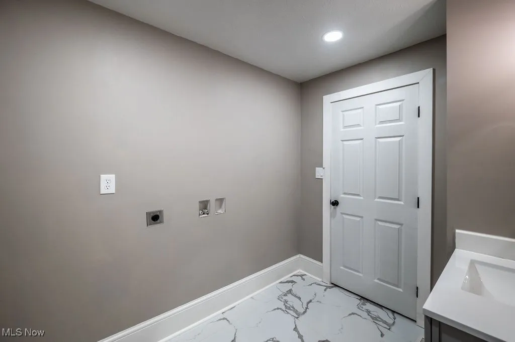 Laundry room featuring marble look tile flooring, washer hookup, hookup for an electric dryer, and recessed lighting