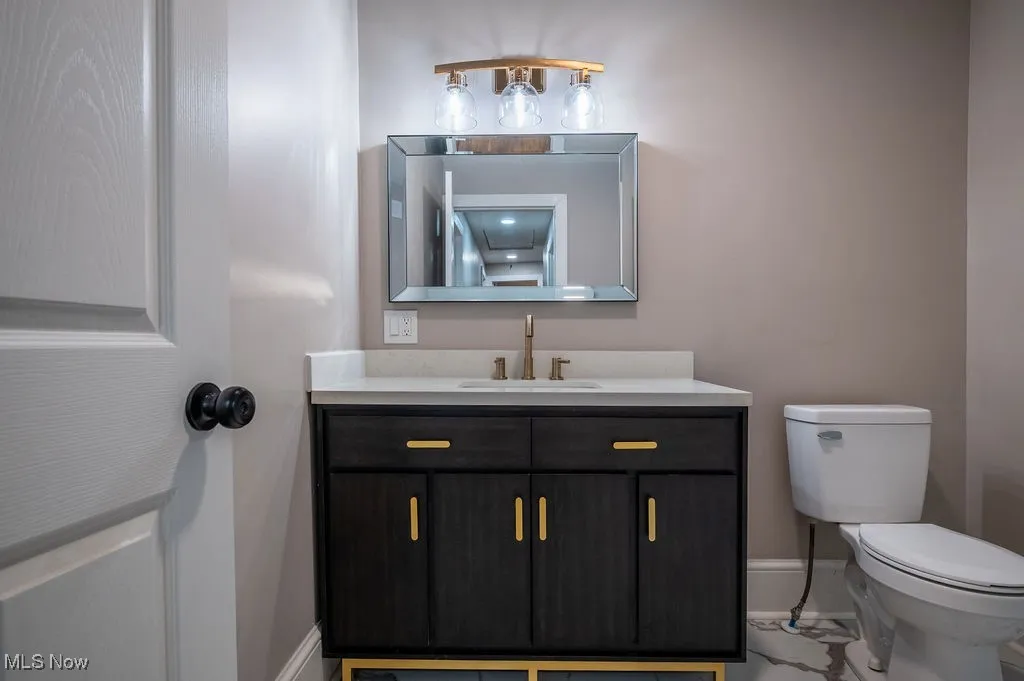 Bathroom featuring vanity and toilet