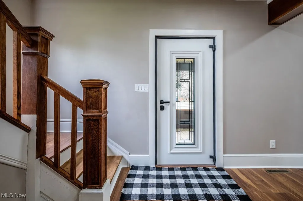 Entrance foyer with wood finished floors and baseboards