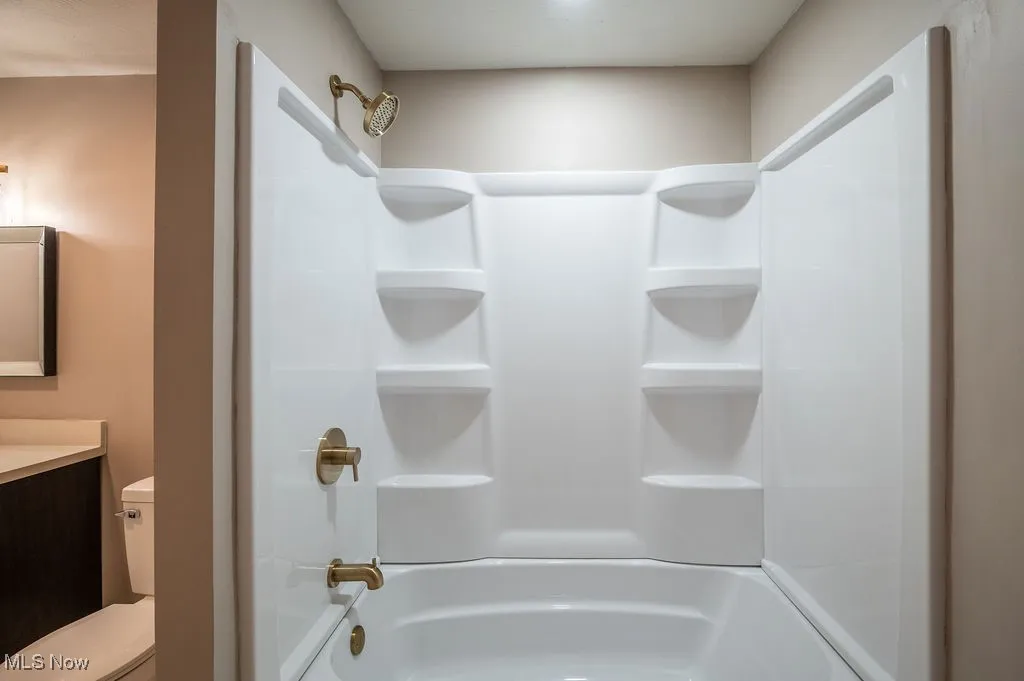 Bathroom featuring vanity and bathtub / shower combination