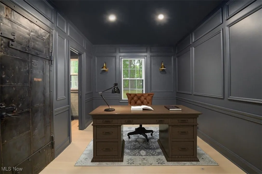 Office area featuring a decorative wall and light wood-style floors