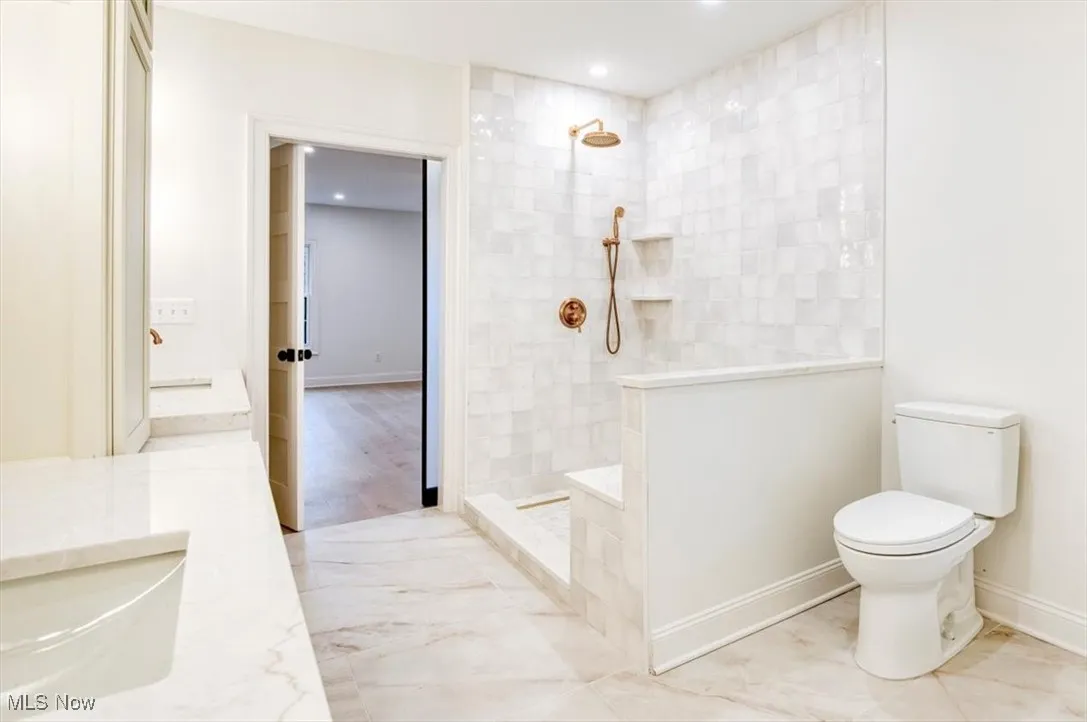 Full bath featuring a walk in shower, recessed lighting, and vanity