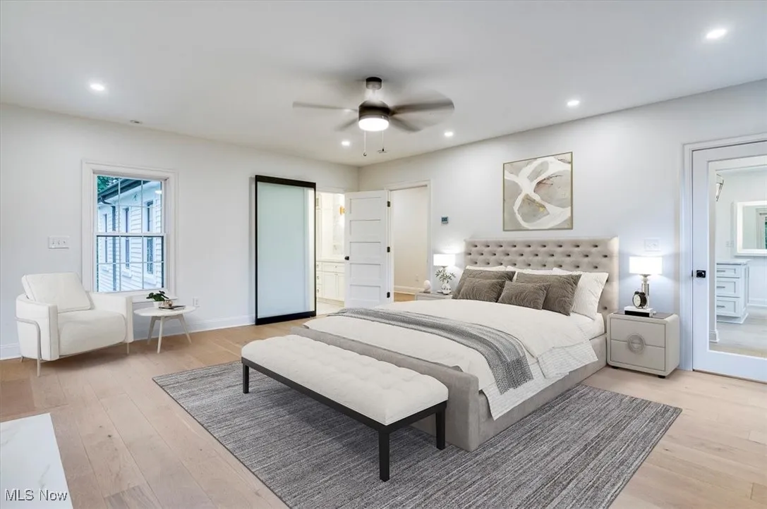 Bedroom featuring light wood-style floors, recessed lighting, a ceiling fan, and ensuite bathroom