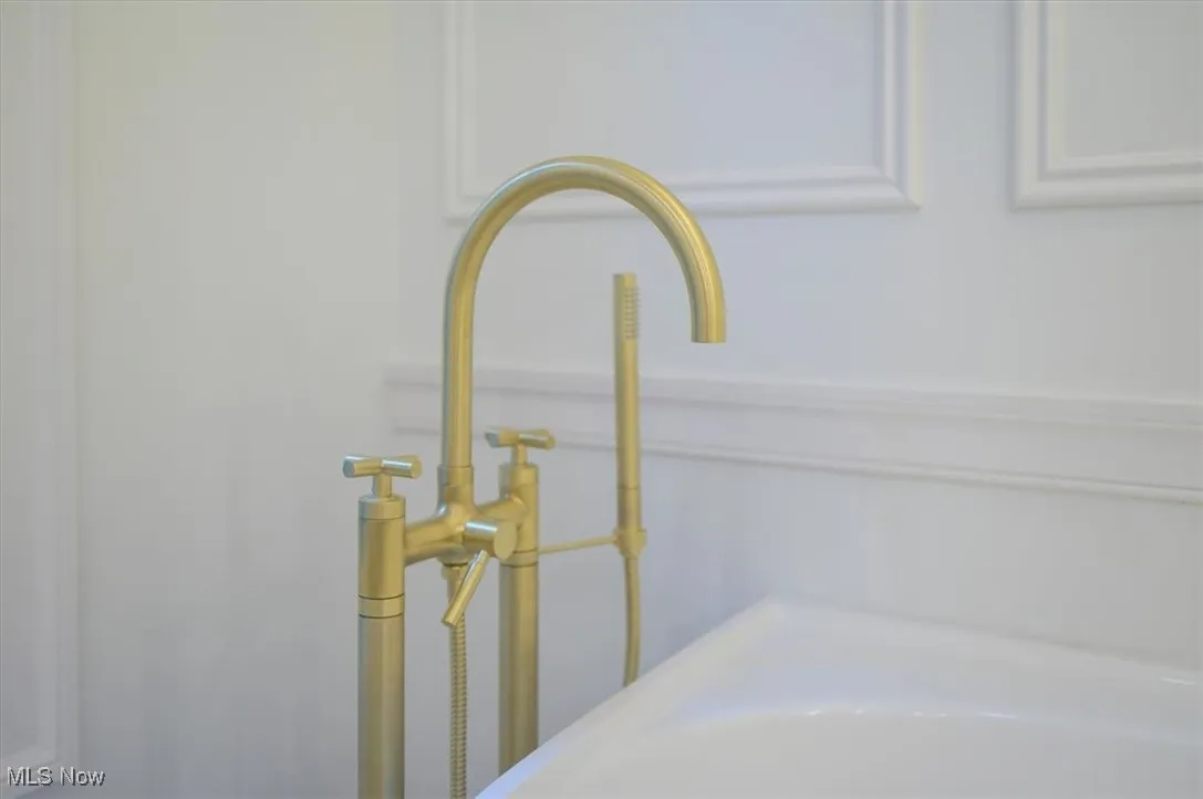 Bathroom view of a soaking tub hardware