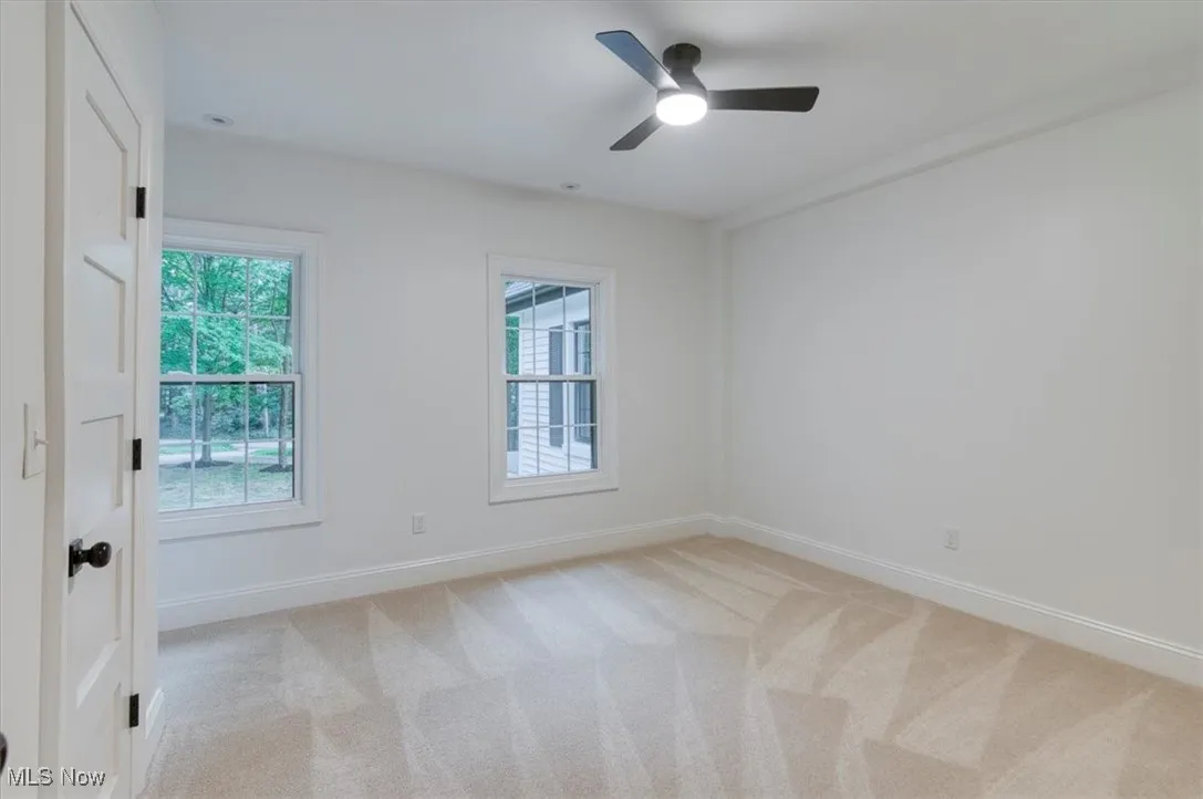 Bedroom with light carpet and ceiling fan
