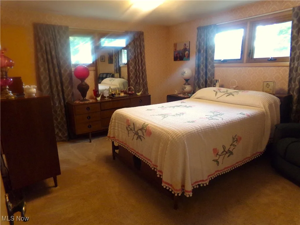 Bedroom featuring wallpapered walls