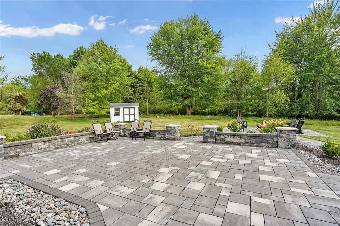 View of patio with a storage unit