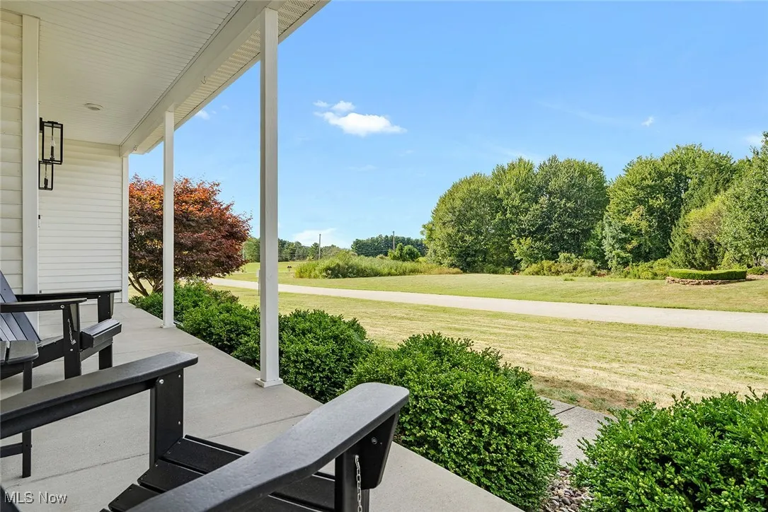 Covered porch with a yard