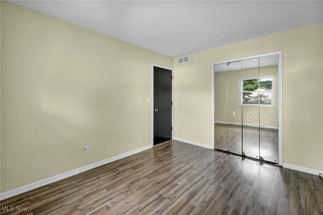 Bedroom featuring wood finished floors and baseboards