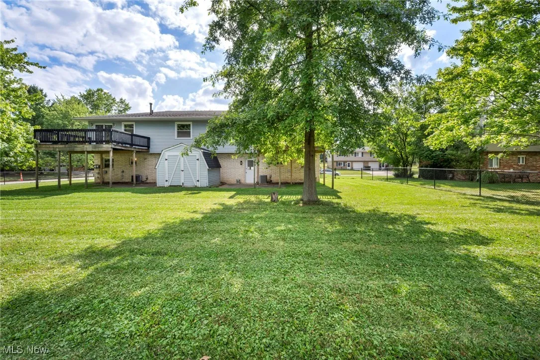 Fenced backyard with a storage shed and private decks for each unit