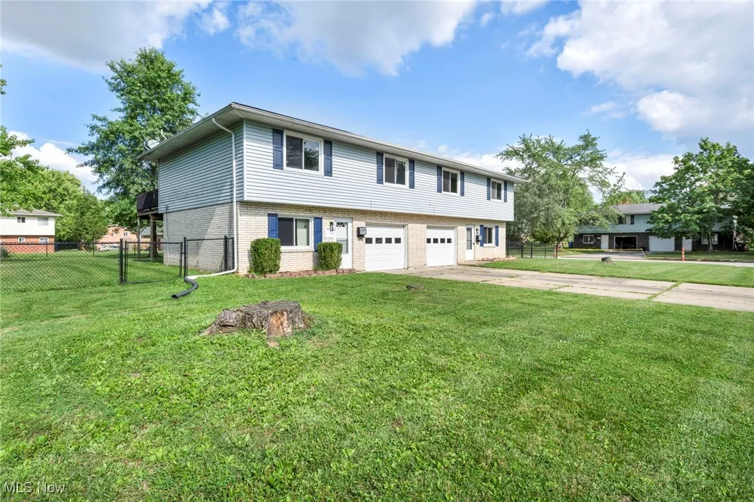 Fenced backyard with a storage shed and private decks for each unit