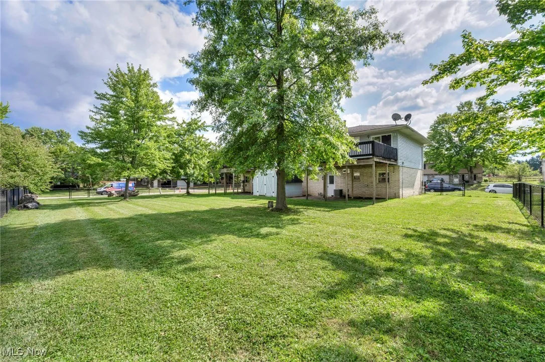 Fenced backyard with a storage shed and private decks for each unit