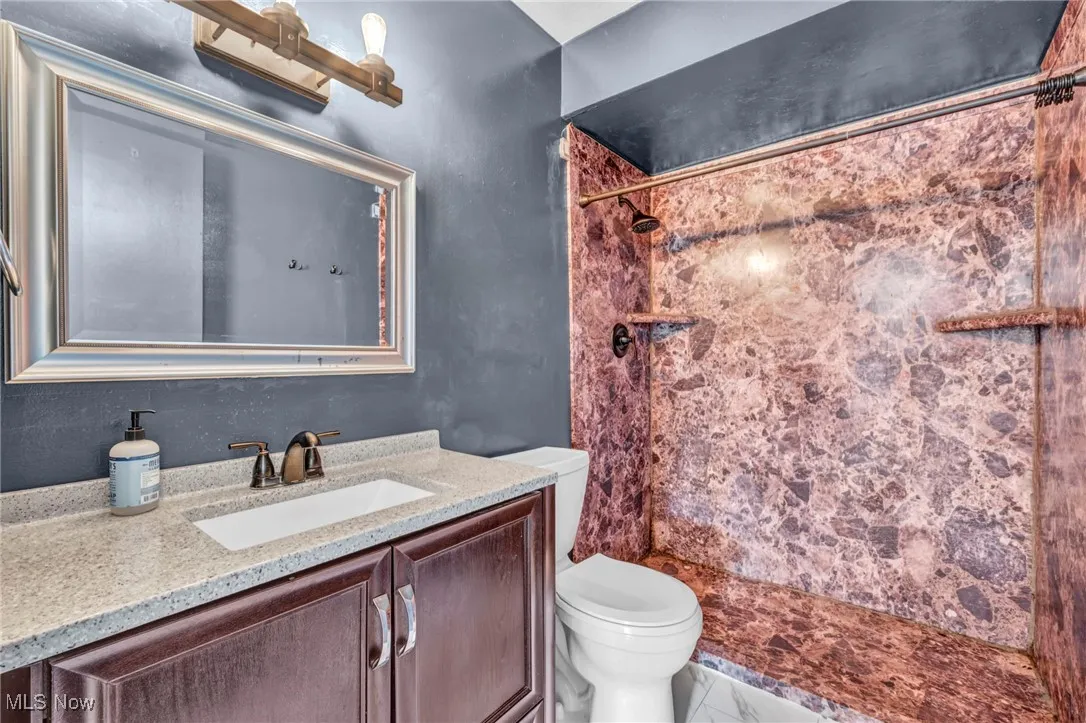 Bathroom featuring vanity and a stall shower
