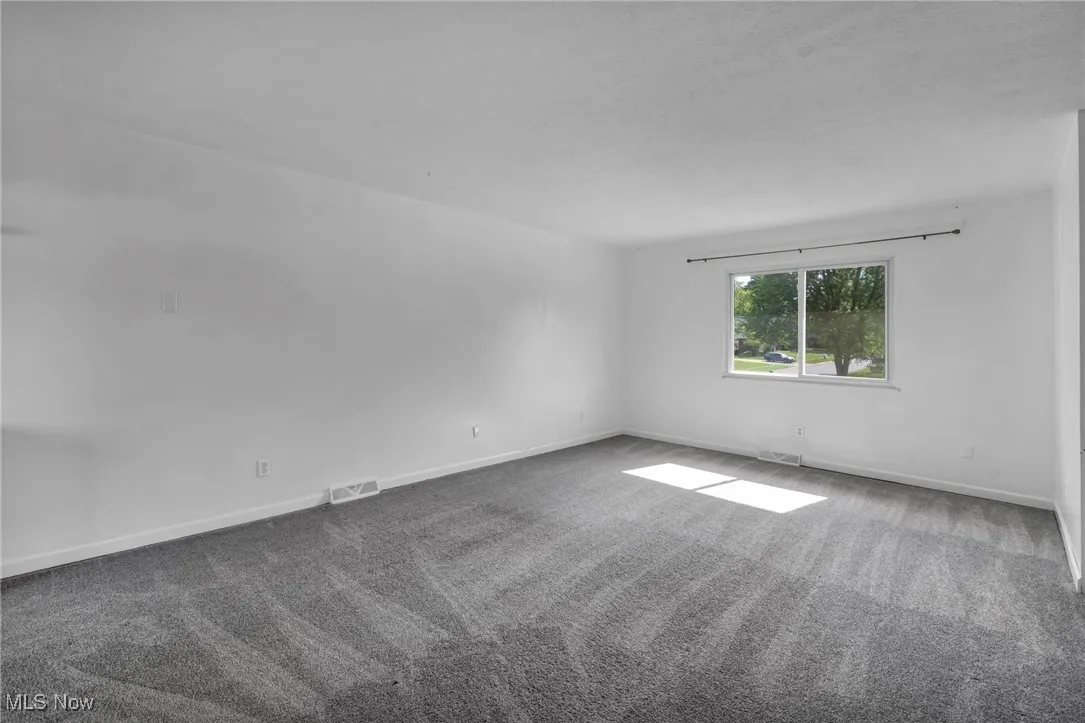Living room with carpet and baseboards