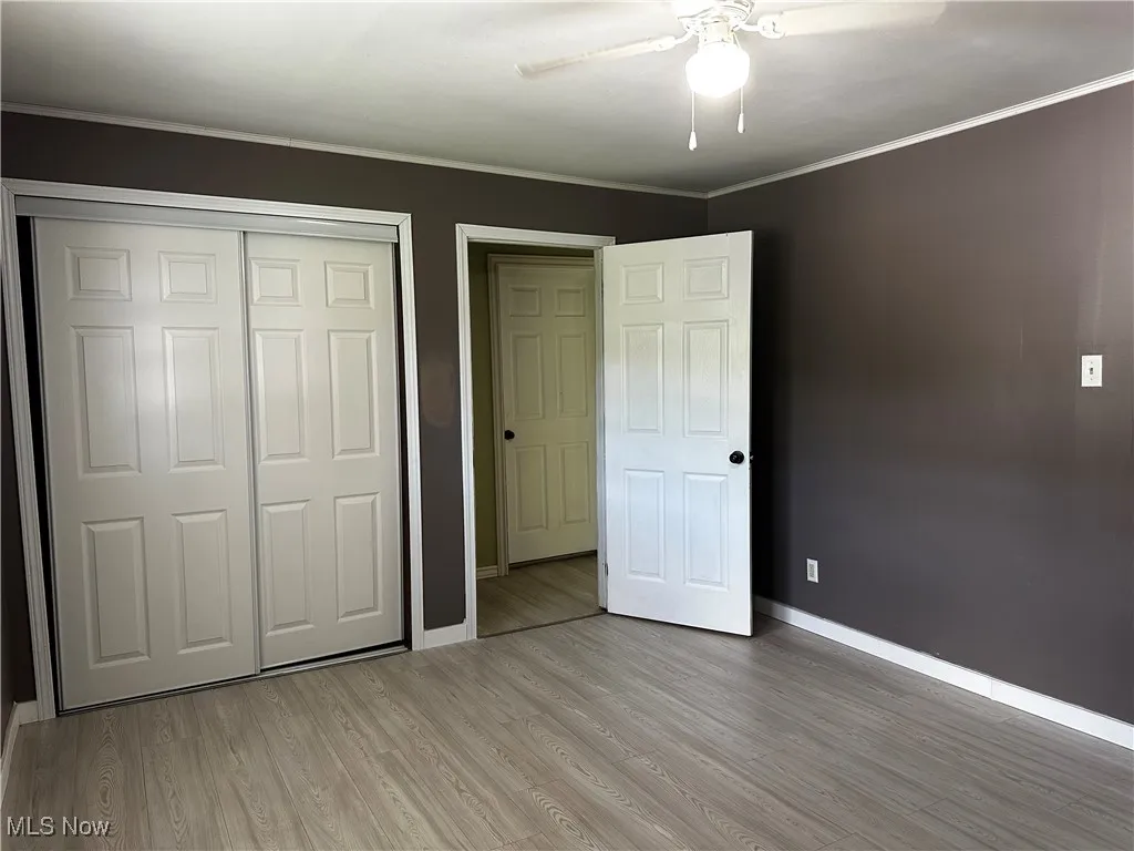 Second bedroom with closest, ceiling fan and entrance door