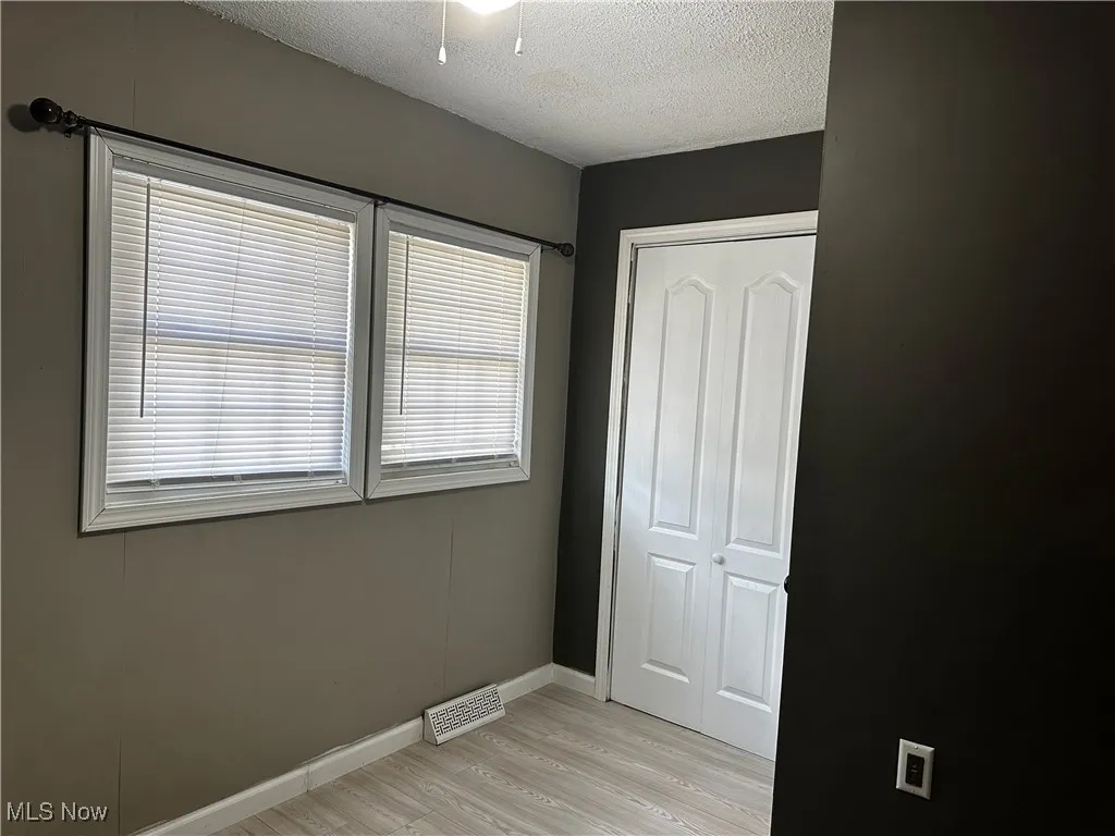 Third bedroom with closest and ceiling fan