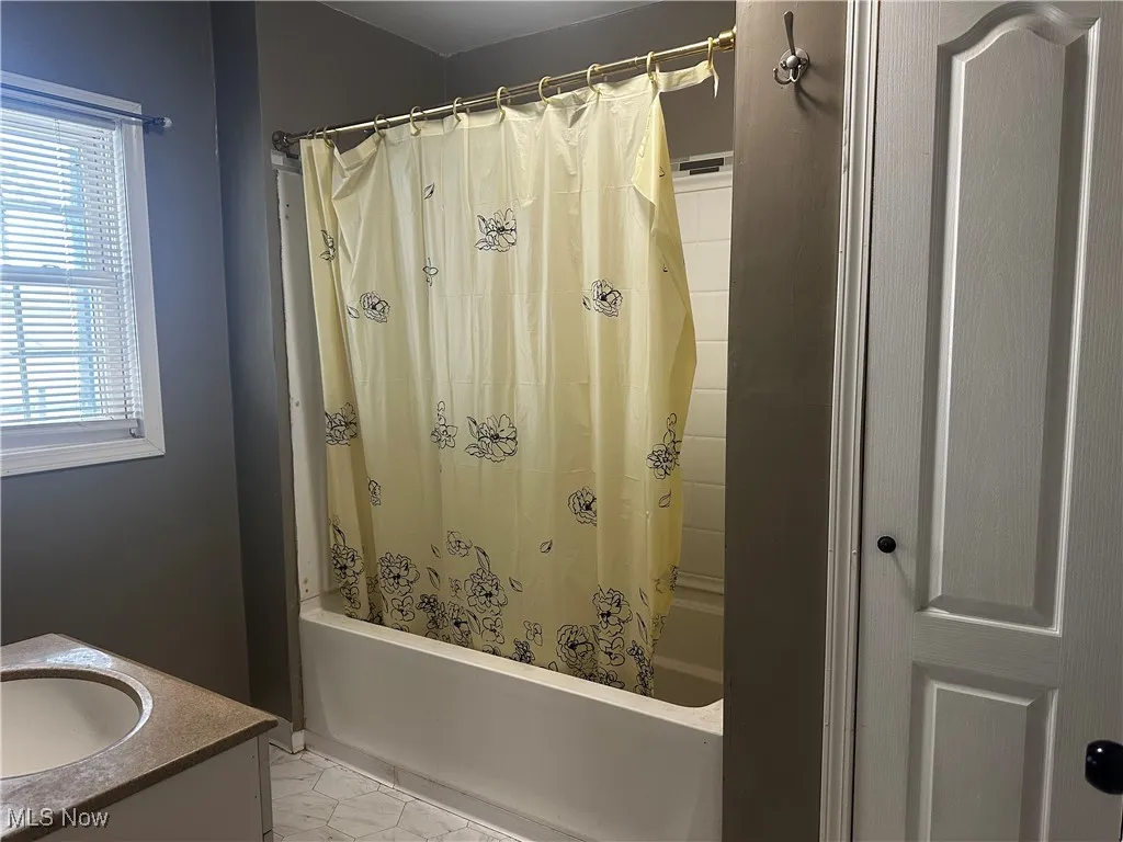 Bathroom with vanity and shower / tub and closet