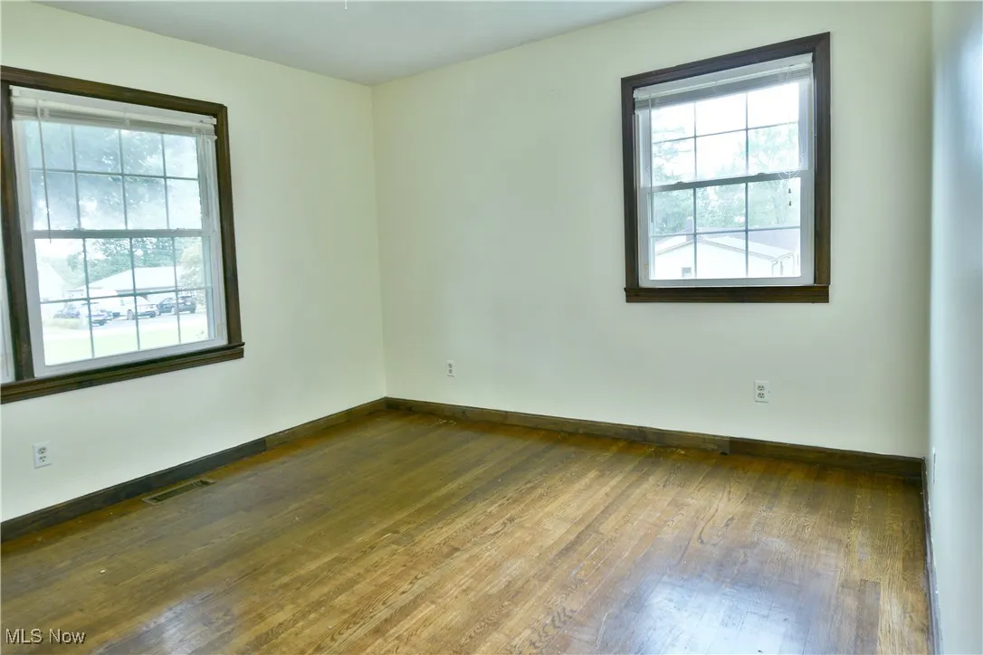 Spare room featuring hardwood / wood-style floors and baseboards