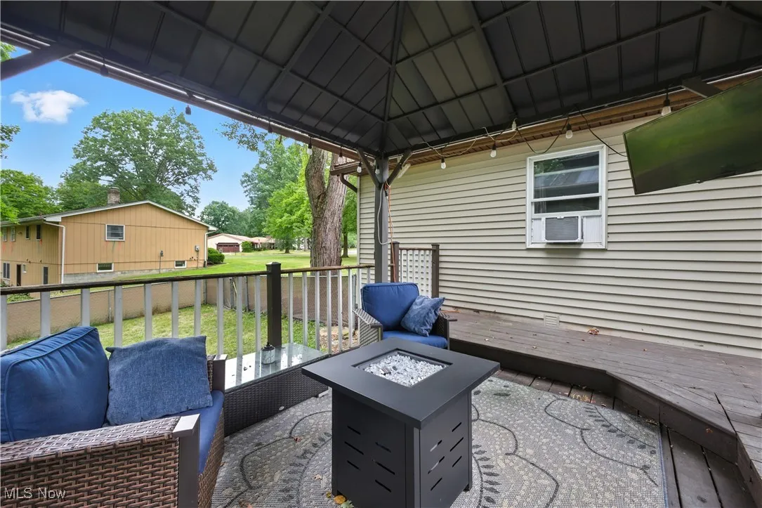 View of patio with an outdoor fire pit