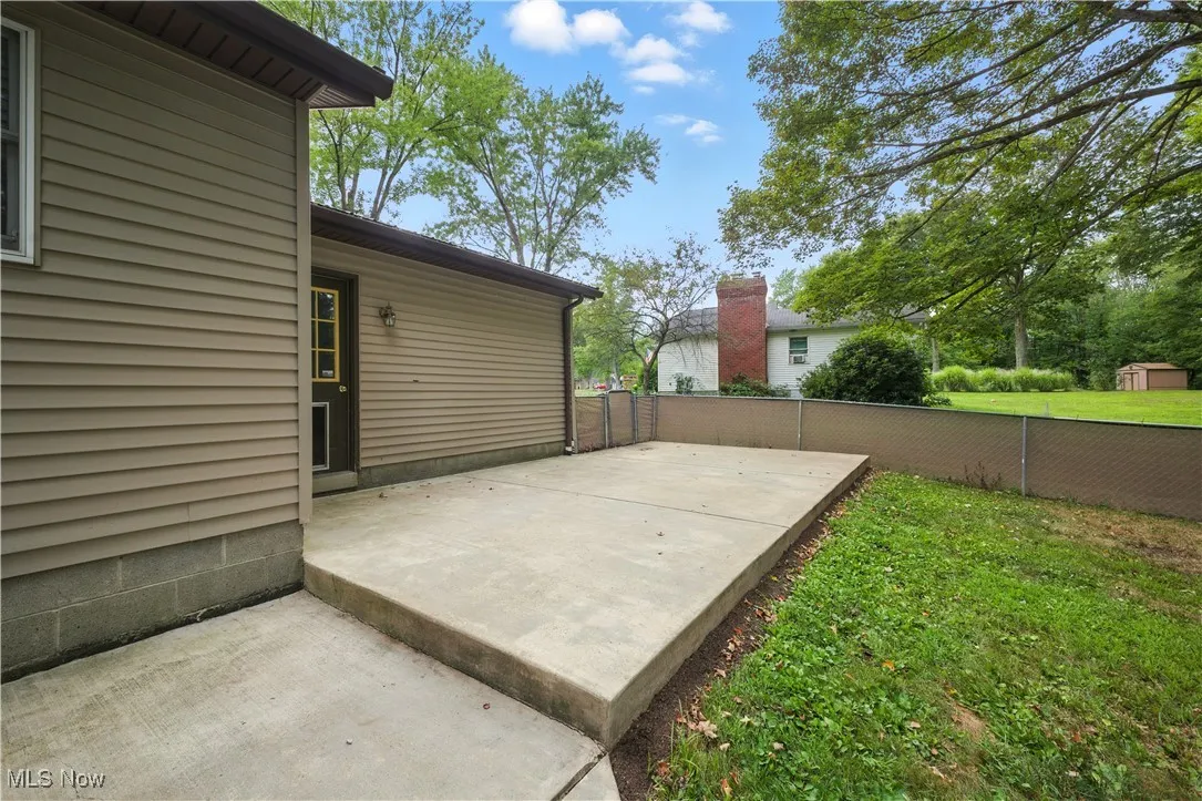 Fenced backyard with a patio area
