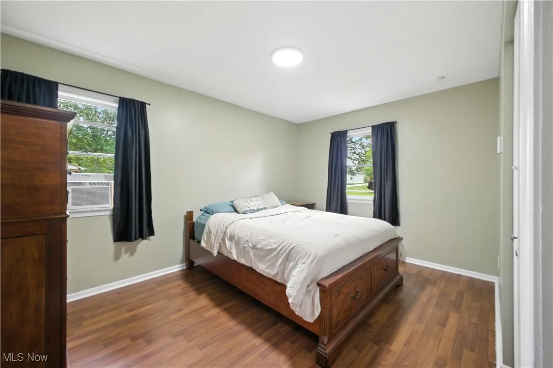 Bedroom featuring dark wood-style flooring