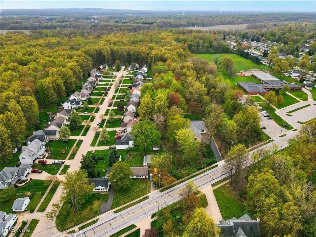 Drone / aerial view featuring a residential view and a view of trees